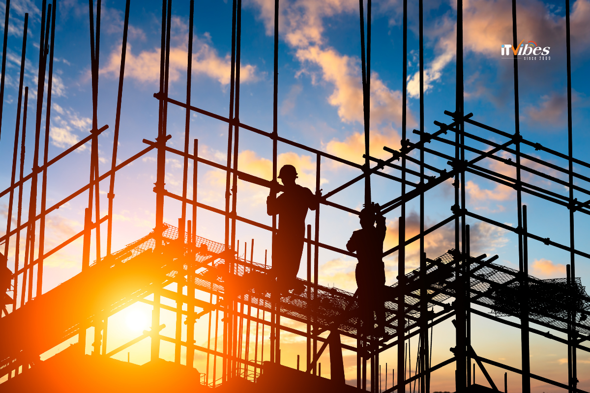 Construction workers on a construction site with the sun setting