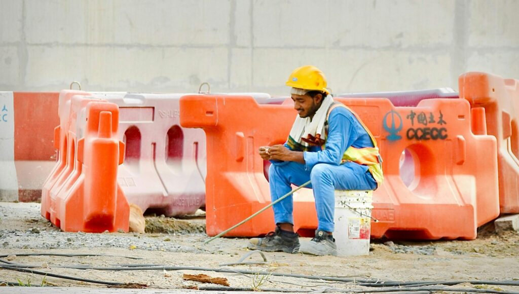 construction worker looking at phone and browsing online