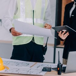 Diverse Team of Specialists Using Table for General Contractor Ads